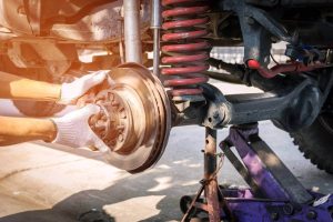 hand-technician-wearing-gloves-repairing-car-brake (Custom)